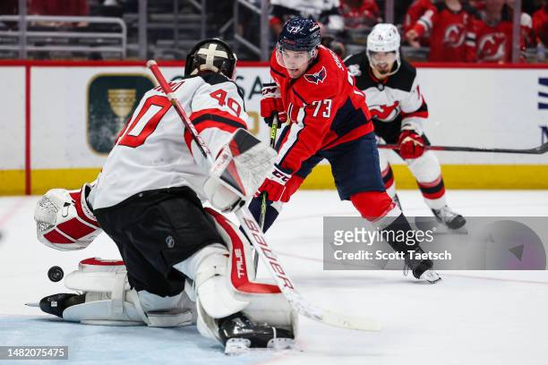 Akira Schmid of the New Jersey Devils makes a save against Conor Sheary of the Washington Capitals during the second period at Capital One Arena on...