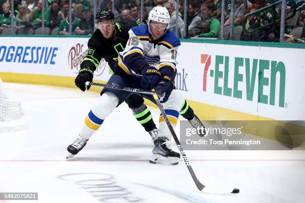 Jakub Vrana of the St. Louis Blues controls the puck against Evgenii Dadonov of the Dallas Stars in the first period at American Airlines Center on...