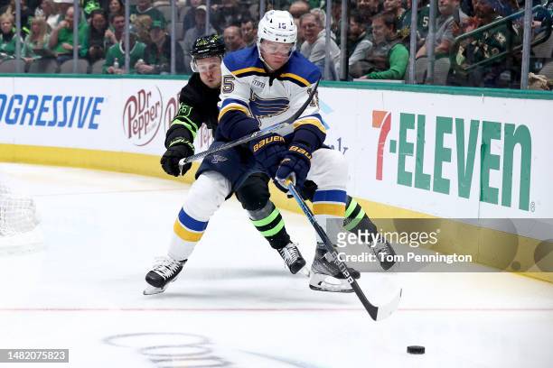 Jakub Vrana of the St. Louis Blues controls the puck against Evgenii Dadonov of the Dallas Stars in the first period at American Airlines Center on...