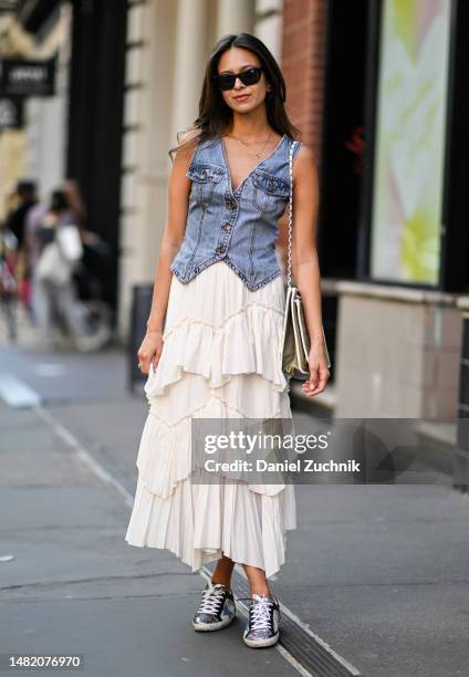 Zein Kurdi is seen wearing a denim vest, Snidel skirt, vintage Chanel bag and Golden Goose sneakers on April 13, 2023 in New York City.