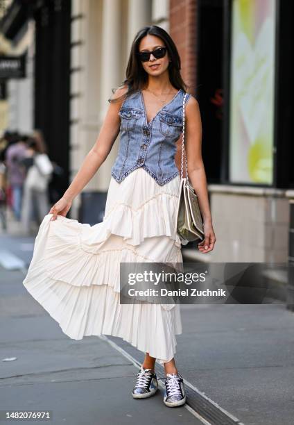 Zein Kurdi is seen wearing a denim vest, Snidel skirt, vintage Chanel bag and Golden Goose sneakers on April 13, 2023 in New York City.