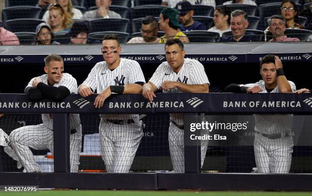 Anthony Rizzo,Aaron Judge, Giancarlo Stanton and Anthony Volpe of the New York Yankees react in the sixth inning against the Minnesota Twins at...