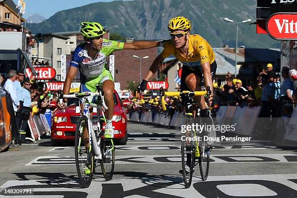 Vincenzo Nibali of Italy riding for Liquigas-Cannondale crosses the finish line with Bradley Wiggins of Great Britain riding for Sky Procycling in...