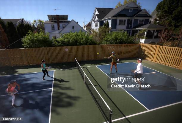 Michelle Ezra, Shelley Caplan, Rob Slattery and Kyle McKinney play pickleball on a backyard court on April 13, 2023 in Bethesda, Maryland. Pickleball...