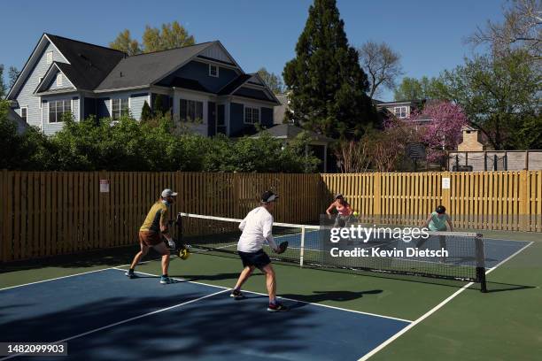 Michelle Ezra, Shelley Caplan, Rob Slattery and Kyle McKinney play pickleball on a backyard court on April 13, 2023 in Bethesda, Maryland. Pickleball...