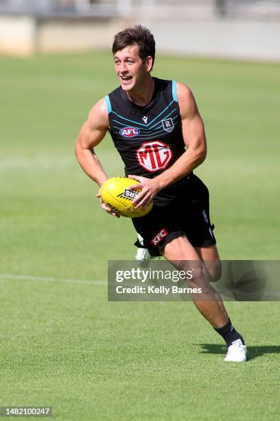 Zak Butters prepares to kick the ball during a Port Adelaide Power AFL training session at Alberton Oval on April 14, 2023 in Adelaide, Australia.