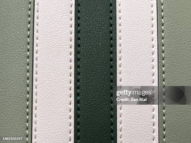 front details of a two-toned green handbag - seam stockfoto's en -beelden