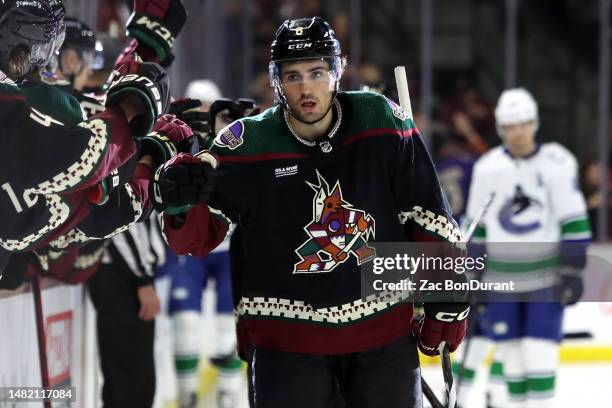 Nick Schmaltz of the Arizona Coyotes celebrates with the bench after scoring his 100th career goal against the Vancouver Canucks during the third...