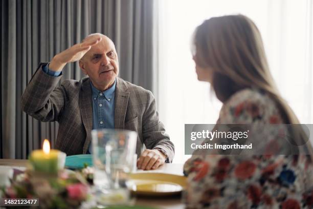 multi generation family sitting at the table for traditional easter breakfast - easter poland stock pictures, royalty-free photos & images