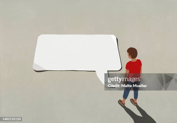 man looking down at large blank communication speech bubble - speech therapy stock illustrations