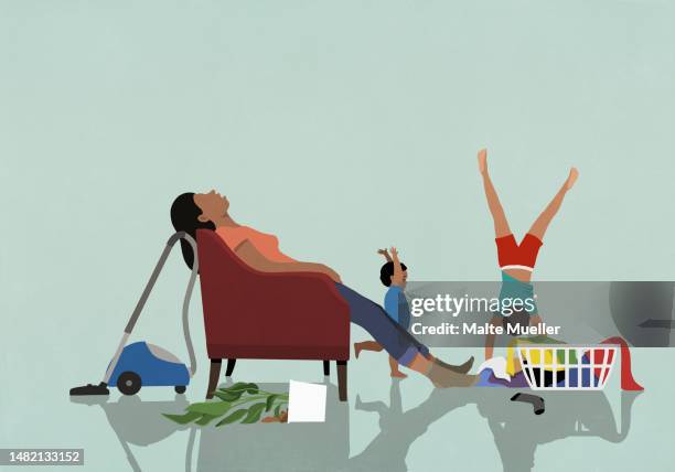 kids playing behind exhausted mother sleeping in armchair at home - tired woman stock-grafiken, -clipart, -cartoons und -symbole