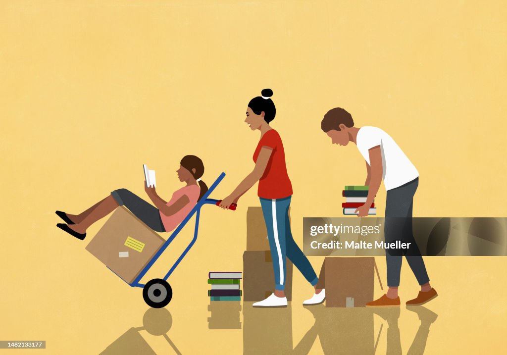 Family reading, packing and moving boxes of books with hand truck