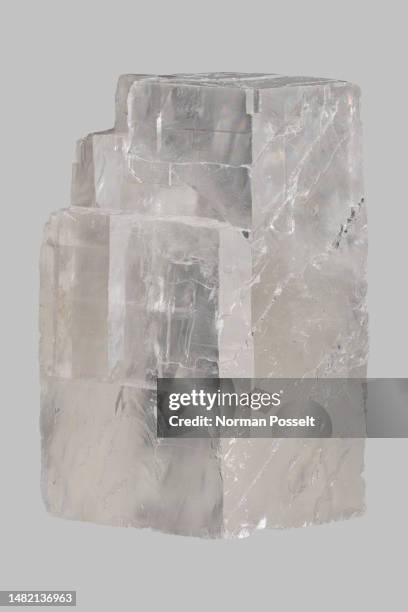 close up translucent icelandic calcite stone on gray background - calcita fotografías e imágenes de stock