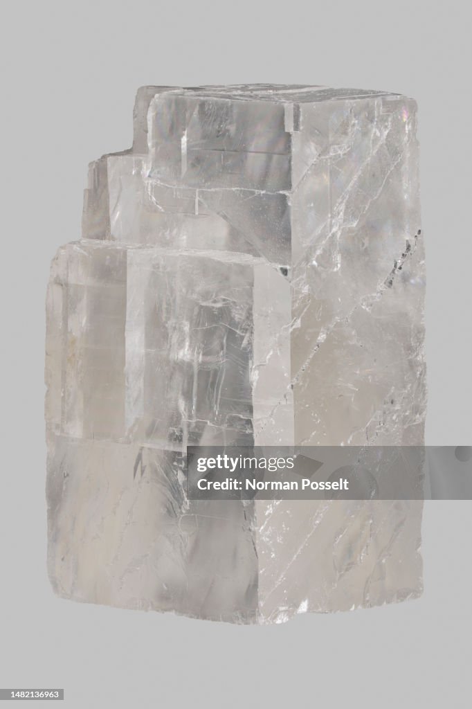 Close up translucent Icelandic calcite stone on gray background