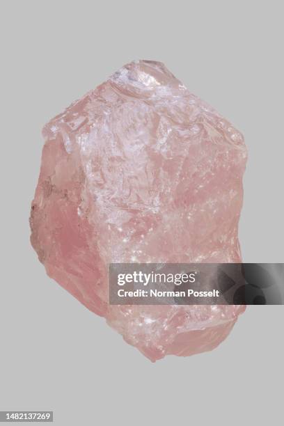 close up pink madagascan rose quartz stone on gray background - opal gemstone stock pictures, royalty-free photos & images