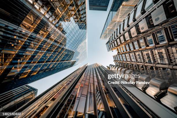 looking directly up at the skyline of the financial district in central london - creative stock image - gebouw exterieur stockfoto's en -beelden
