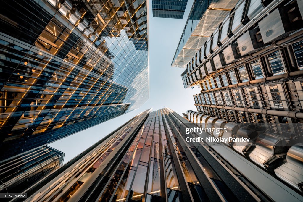 Looking directly up at the skyline of the financial district in central London - creative stock image