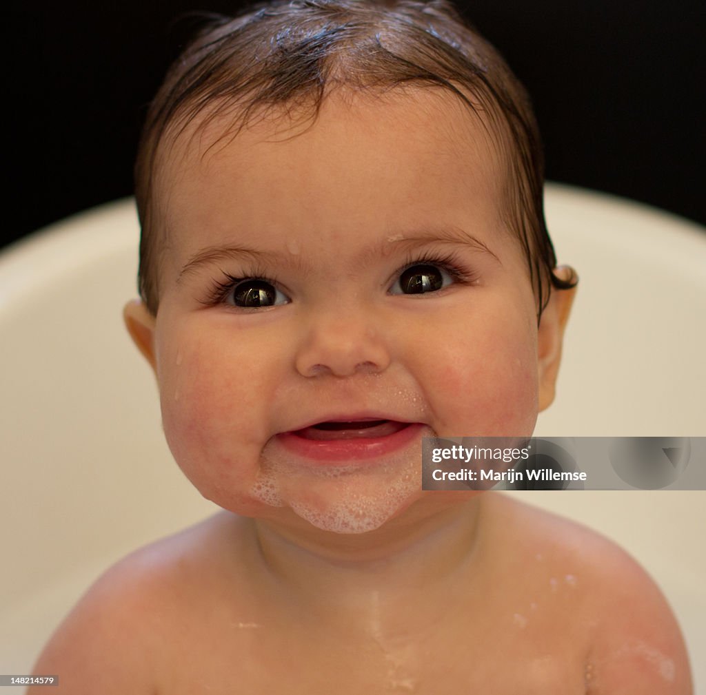 Cute baby in bath smiling