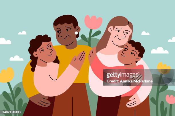 a mixed race son and daughter hug their two moms for mother's day - family stock illustrations