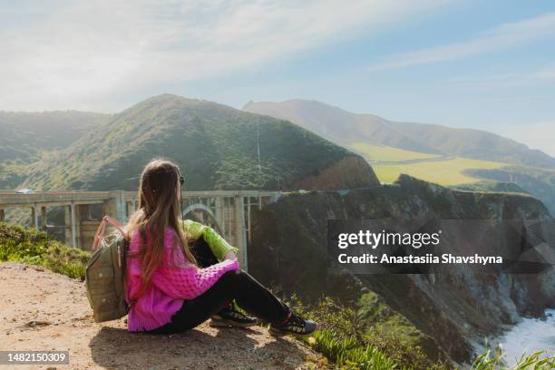 woman traveler relaxing with view of scenic bixby creek bridge in big sur, california - knitted car stock pictures, royalty-free photos & images