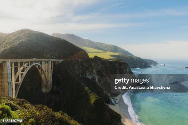 view of car on bixby creek bridge at scenic coastline of big sur, california - monterey california stock pictures, royalty-free photos & images