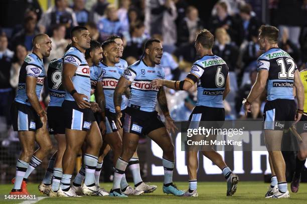 Sione Katoa of the Sharks celebrates with team mates after a try scored by team mate Briton Nikora of during the round seven NRL match between the...