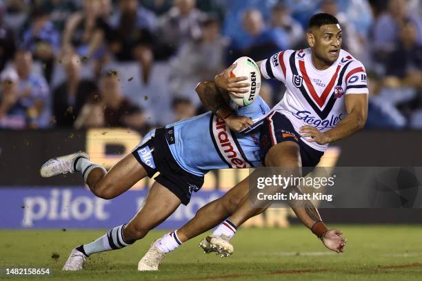 Daniel Tupou of the Roosters is tackled during the round seven NRL match between the Cronulla Sharks and Sydney Roosters at PointsBet Stadium on...