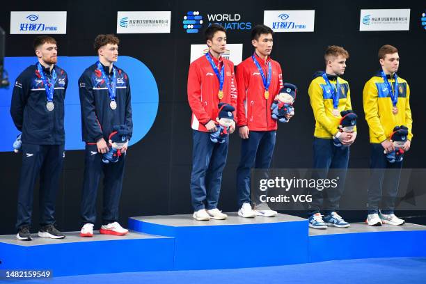 Gold medallists Yang Hao and Lian Junjie of China pose on the podium after the Men's 10m Synchro Platform final on day one of World Aquatics Diving...