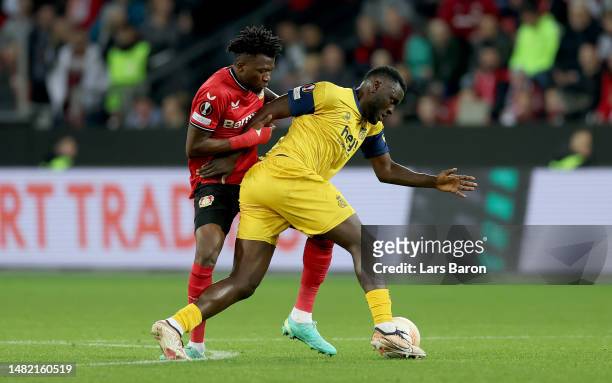 Edmond Tapsoba of Leverkusen challenges Victor Boniface of Royale Union Saint-Gilloise for the ball during the UEFA Europa League quarterfinal first...