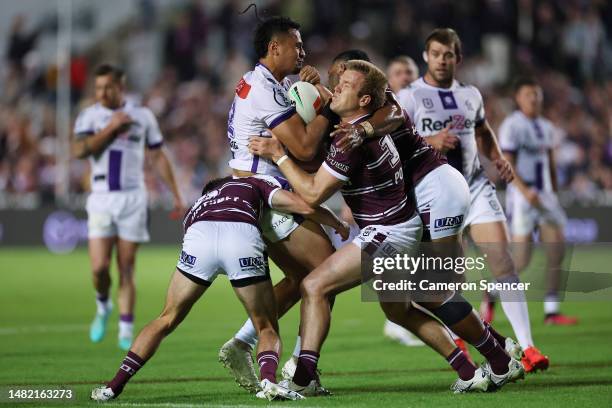 Eliesa Katoa of the Storm is tackled during the round seven NRL match between the Manly Sea Eagles and Melbourne Storm at 4 Pines Park on April 14,...