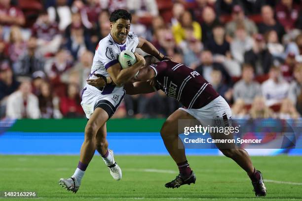 Reimis Smith of the Storm is tackled during the round seven NRL match between the Manly Sea Eagles and Melbourne Storm at 4 Pines Park on April 14,...