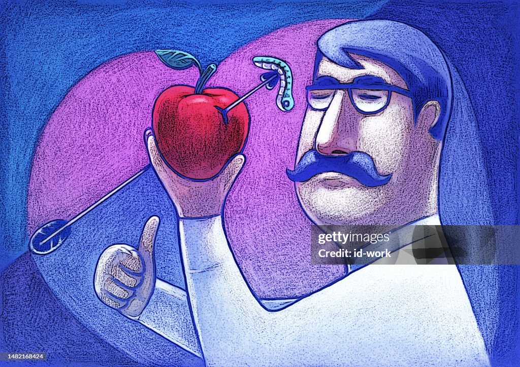 Man holding apple and gesturing thumbs up