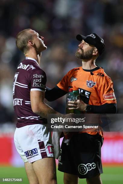 Daly Cherry-Evans of the Sea Eagles is attended to by a trainer after a late tackle by Tui Kamikamica of the Storm during the round seven NRL match...