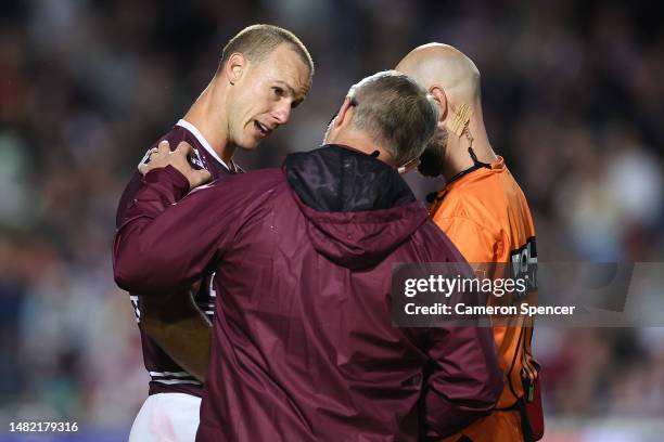 Daly Cherry-Evans of the Sea Eagles is attended to by a trainer after a late tackle by Tui Kamikamica of the Storm during the round seven NRL match...