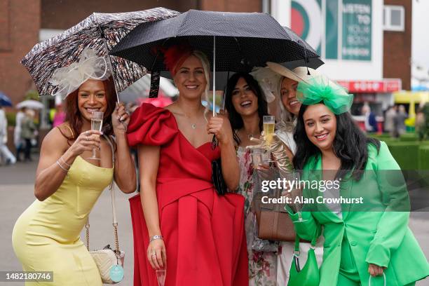 Fashion on a wet day on Ladies Day during the second day of the Grand National Festival at Aintree Racecourse on April 14, 2023 in Liverpool, England.