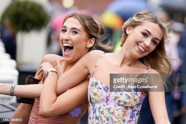 Fashion on a wet day on Ladies Day during the second day of the Grand National Festival at Aintree Racecourse on April 14, 2023 in Liverpool, England.