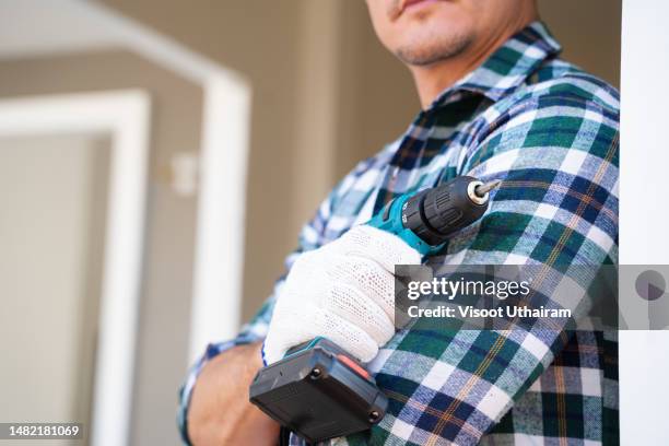 electrician with construction tools and electric drill,installation work. - power tool stock pictures, royalty-free photos & images