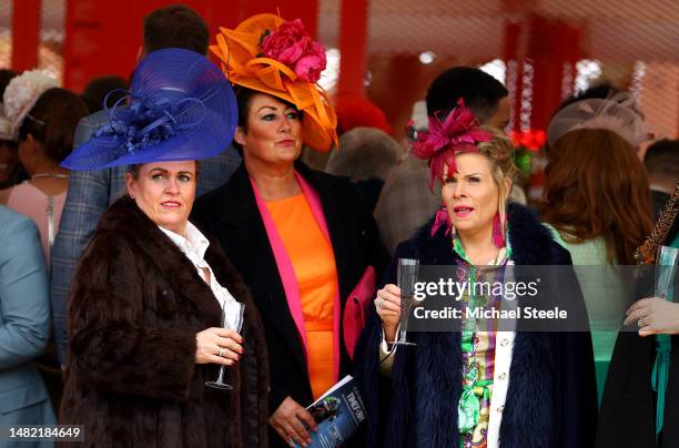 Race goers are pictured on Ladies Day during the second day of the Grand National Festival at Aintree Racecourse on April 14, 2023 in Liverpool,...