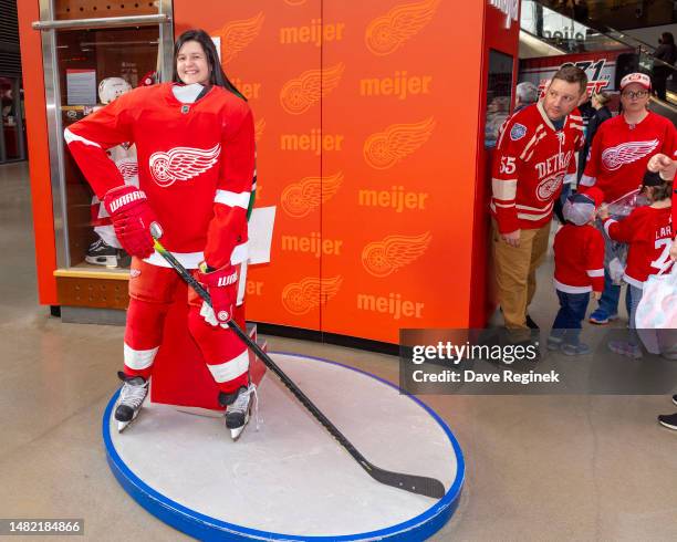 Fan has her picture taken behind a Detroit Red Wings player mock up before an NHL game against the Dallas Stars at Little Caesars Arena on April 10,...