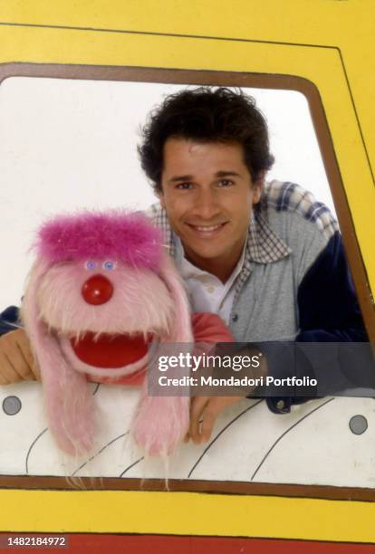 Italian TV host Marco Bellavia in Bim Bum Bam TV studio together with puppet Uan. Italy, 1996