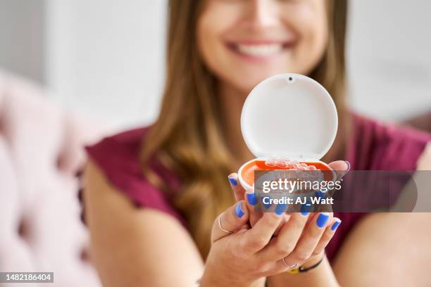 orthodontic retainers box in hands of a woman - invisalign stock pictures, royalty-free photos & images