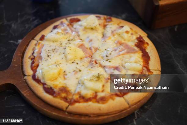 hawaiian pizza on wooden tray - hawaiian pizza stock pictures, royalty-free photos & images