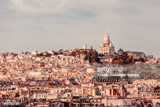 paris cityscape with sacre coeur basilica and montmartre on a sunny day, paris, france - centro storico foto e immagini stock