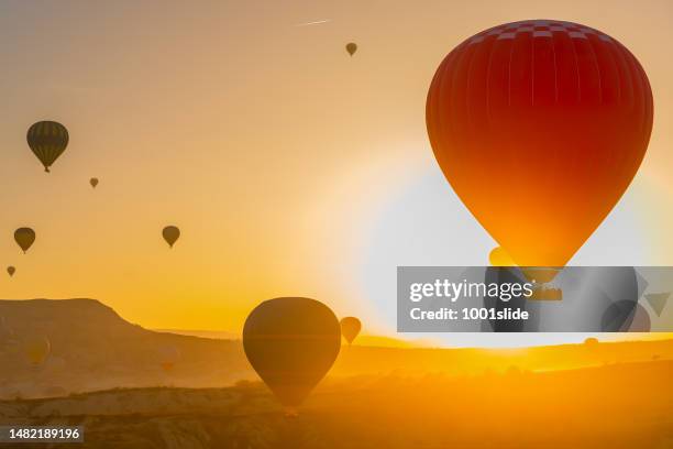 hot air balloons at love valley in cappadocia - cave fire stock pictures, royalty-free photos & images