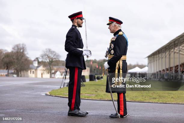 Britain's King Charles III presents an award to the winner of The International Sword, Officer Cadet J S J A Al Sabah, State of Kuwait during the...