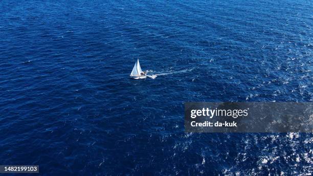 the joy of travel: a beautiful yacht sailing freely in the open sea - yacht white sails stock pictures, royalty-free photos & images