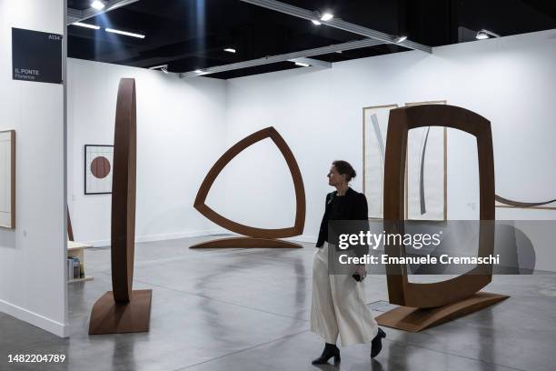 Woman walks past some artworks by Italian artist Mauro Staccioli, during Miart at Allianz MiCo on April 14, 2023 in Milan, Italy. Miart is an...