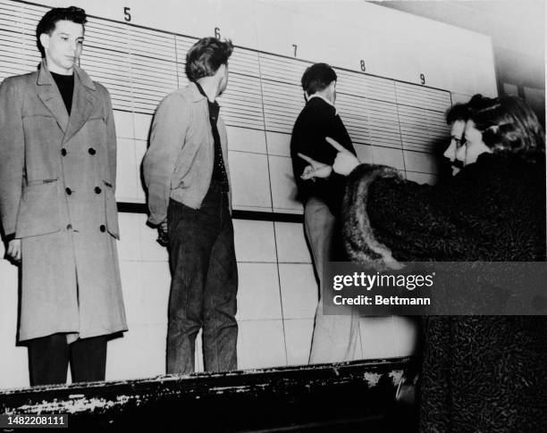 Sylvia Simon identifies Robert Baldi as the murderer of her father during a police line-up in Chicago on April 6th, 1953. Baldi had shot Morris...