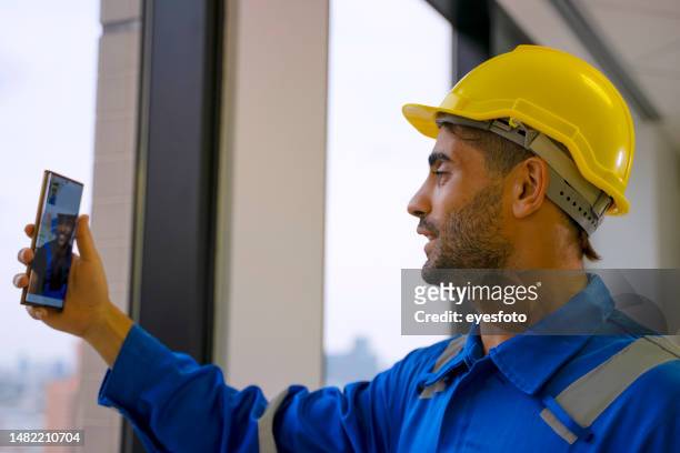construction worker work in the building. - middle eastern male on phone isolated stock pictures, royalty-free photos & images