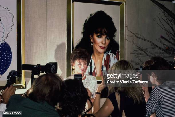 Joan Collins promotes Revlon's 'Scoundrel' perfume in New York City, New York, United States, 20th July 1983.
